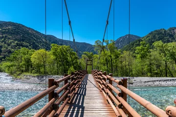 Fotobehang Chocoladebruin Kamikochi bridge over stream  © Prism6 Production
