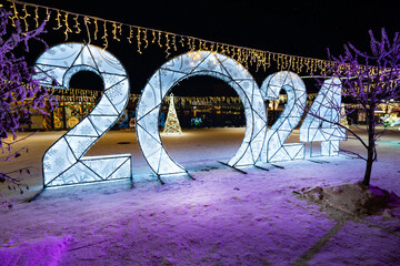 Happy New Year 2024. Sparkling burning numbers Year 2022 with on black background. christmas street decorations. Beautiful design element.