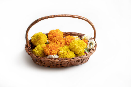 Marigold (Zendu Flowers) flowers in a bamboo basket Colorful Marigold Flower in wooden basket on white background