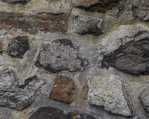 Stony background with space for text. it is a wall with beton and different stones