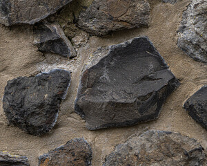 Stony background with space for text. it is a wall with beton and different stones