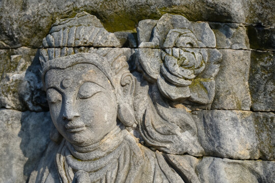 stone statue. stone art girl with stone flower above her head, art concept