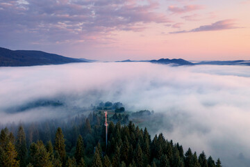 An incredible view from a drone of a valley covered in thick fog.