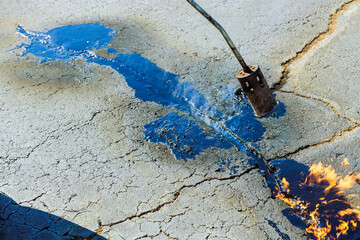 Bitumen emulsion joint seal restorer is used to repair cracks in asphalt surfaces by filling them...