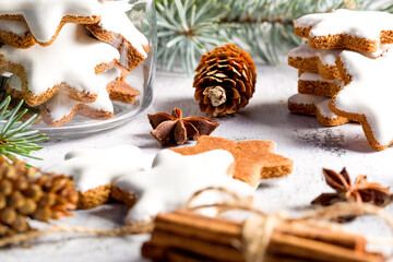 Traditional Christmas glazed gingerbread cookies in the shape of a star. Cookies for the holiday. New Year's decor. White background