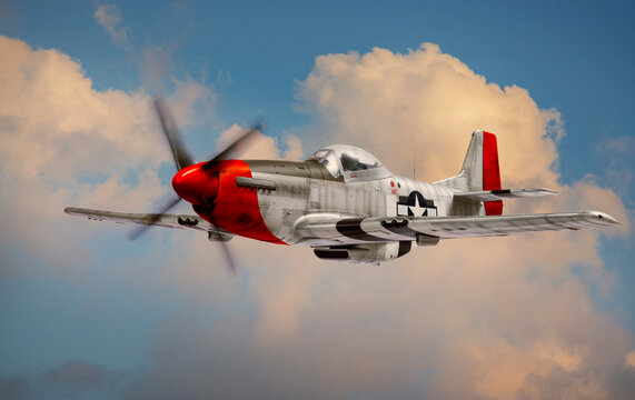 P-51 Mustang World War II era fighter with Red Tail squadron paint scheme flies among clouds