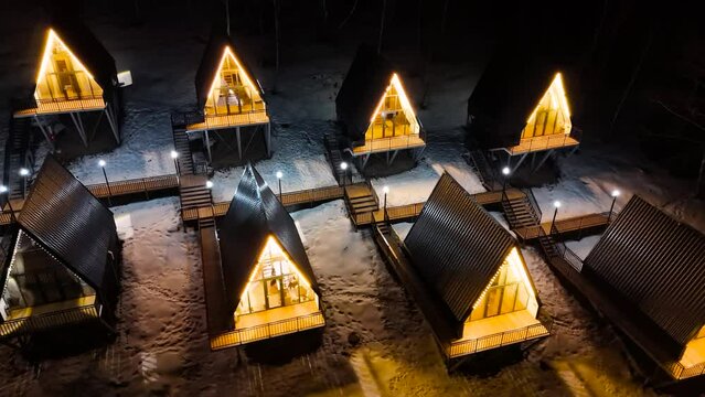 A Frame cabins at night in the winter park