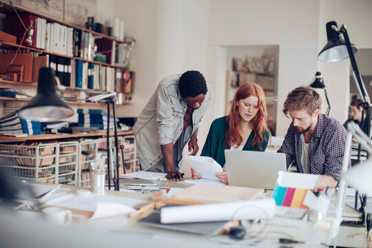 Diverse young architects working in modern office