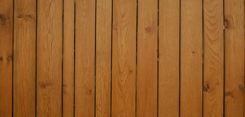 This image shows a close-up view of a wooden surface, characterized by horizontal planks with visible grains and textures. The wood has a dark brown color, and the lines between the planks are clearly