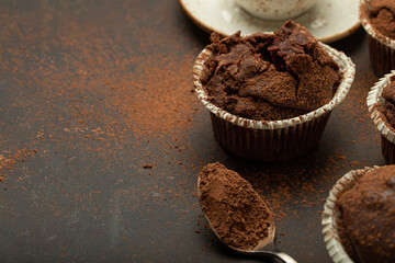 Chocolate and cocoa browny muffins with coffee cappuccino in cup angle view on brown rustic stone...