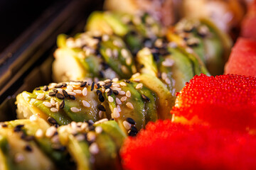 A set of delicious sushi rolls Red caviar on sushi rolls.