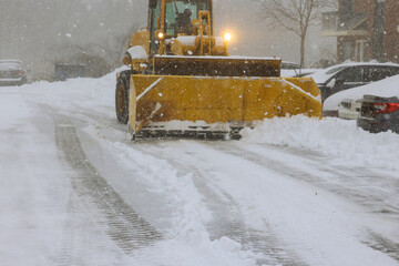 Snowplow trucks remove snow from parking lots following heavy snowfalls