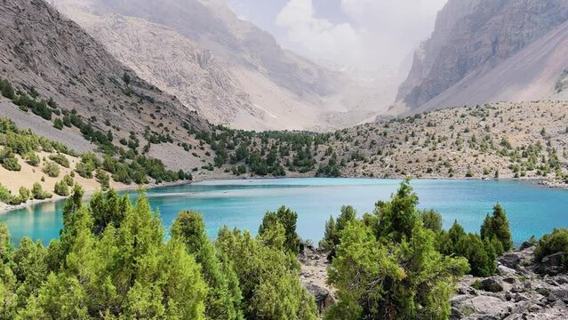 The Alaudin (Chapdara) lakes, lying at an altitude of 2800 m, are considered one of the most beautiful lakes of the Fan Mountains. Turquoise mountain lake. Pamiro-Alai. Tajikistan, Pamir 4K