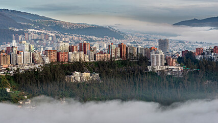 Gonzalez Suarez district skyscrapers above the Guapulo valley with mist - obrazy, fototapety, plakaty