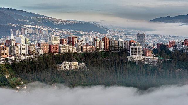 Gonzalez Suarez district skyscrapers above the Guapulo valley with mist