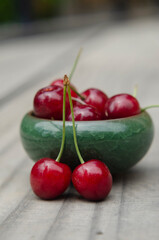 closeup of freshly harvested sweet red cherry on rustic wood with selective focus