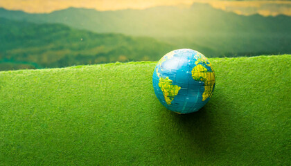 earth globe on grass - obrazy, fototapety, plakaty