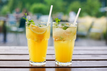Trendy summer drinks with orange on the table in the cafe