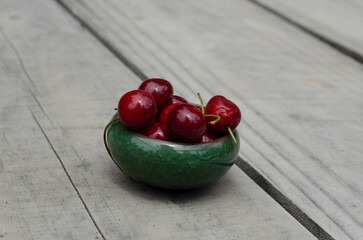 cherries in close-up in wooden surroundings, fresh sweet patagonian red fruits