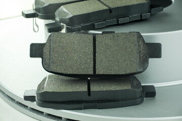 Black brake pads for the car, on brake discs for the car.