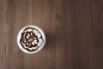 Fototapeta na wymiar Latte art on milk foam with mocha ice coffee. Top view with copy space.