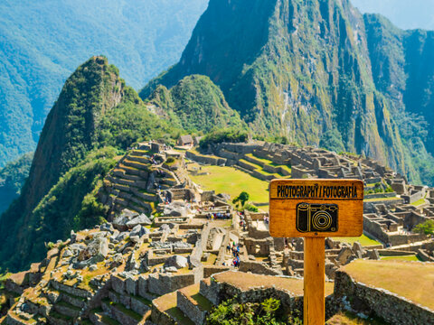 Panoramic viewpoint of the lost Inca city Machu Picchu, with wooden photography sign in foreground, Sacred valley of Incas, Cusco region, Peru