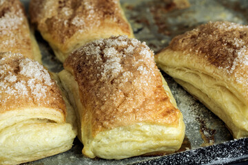 Puff pastry dough. Folded baked puff pastry pies portions,