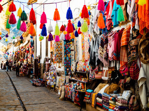 Colorful alley with handmade souvenirs in traditional Pisac market, Sacred valley of Inca, Cusco region, Peru

