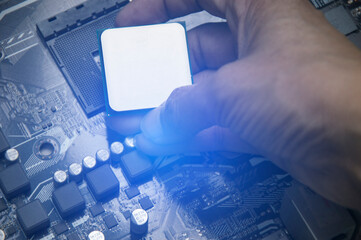 Top view of technician installing CPU chip on motherboard, CPU chip It's the brain part of the...