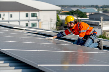 Side view industrial technician worker touch to check and maintenance solar cell panels on rooftop...