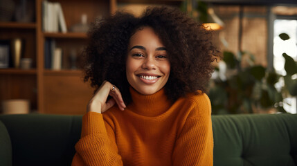 Smiling woman with curly hair in a warmly lit room