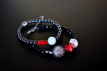 A set of beaded bracelets on a black background