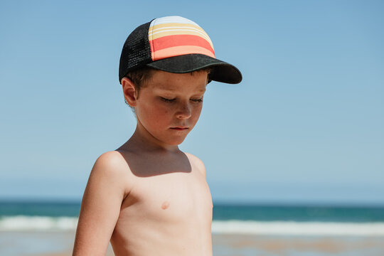Young boy in thought at the beach