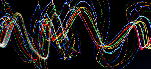 A photograph of vibrant multi-color lights in a long exposure photo. Light painting photography