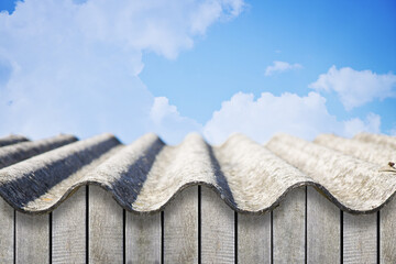 Old aged roof made of corrugated asbestos panels - dangerous materials in buildings and construction industry - obrazy, fototapety, plakaty