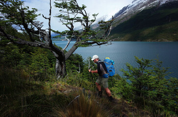 Hiking in Patagonia, Man trekking along the Del Desierto Lake in Argentina - obrazy, fototapety, plakaty