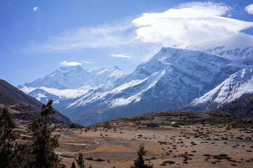 a vast high-altitude plateau with the grandeur of the snow-capped Himalayas rising in the background