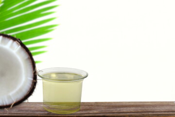 organic coconut cream oil in jar with palm coconut fruit with leaves in white background,copy space