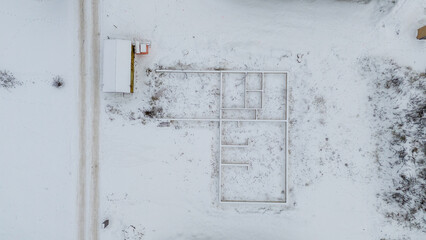 Drone photography of a personal house construction site in a rural setting during winter