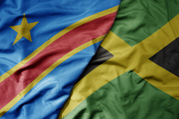 big waving national colorful flag of jamaica and national flag of democratic republic of the congo .
