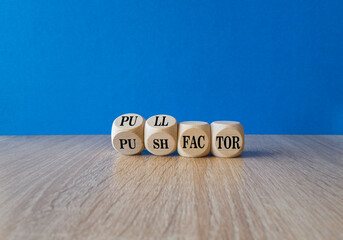 Pull or push factor symbol. Concept word Pull factor and Push factor on wooden cubes. Beautiful...