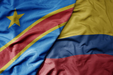 big waving national colorful flag of colombia and national flag of democratic republic of the congo...