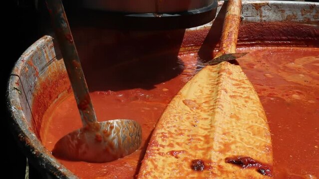 Tomato soup with pasta is a dish of Polish cuisine. Hot Zupa pomidorowa in a large cauldron at the field kitchen at a food fair. A popular soup made from grated tomatoes in their own juice.
