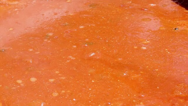 Tomato soup with pasta is a dish of Polish cuisine. Hot Zupa pomidorowa in a large cauldron at the field kitchen at a food fair. A popular soup made from grated tomatoes in their own juice.