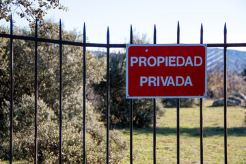 Fototapeta premium Translation: Private property. Private property sign Iron bar gate on a dry stone fence that gives access to a privately owned pasture