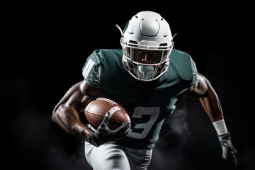 Portrait of American football player running with the ball. Muscular African American athlete in a green and white uniform with an ovoid ball in a dynamic pose. Isolated on black background. - obrazy, fototapety, plakaty
