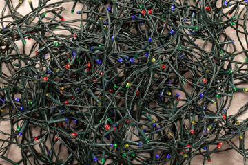 Close-Up Pile of LED Christmas Lights on Floor - Festive Aftermath Background
