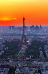 cityscape of Paris with Eiffel Tower from above in orange sunset sunlight, France