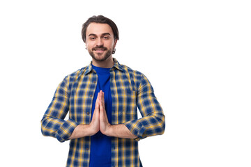 handsome brunette macho man with a beard in a blue shirt on a white background actively gesturing...