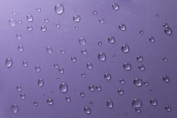 Water drops on lavender background, top view